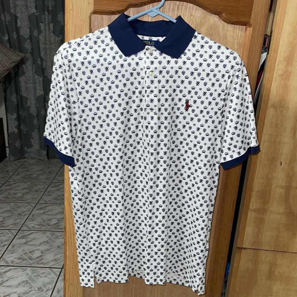 White Ralph Lauren Polo Shirt with Royal Blue Emblems Pattern.